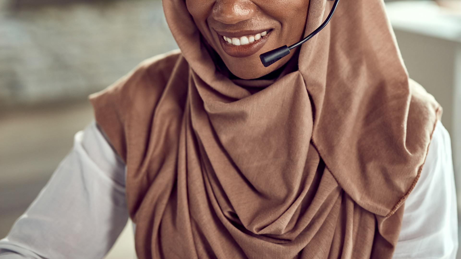 Call centre technician smiling while using the VHI CRM app.